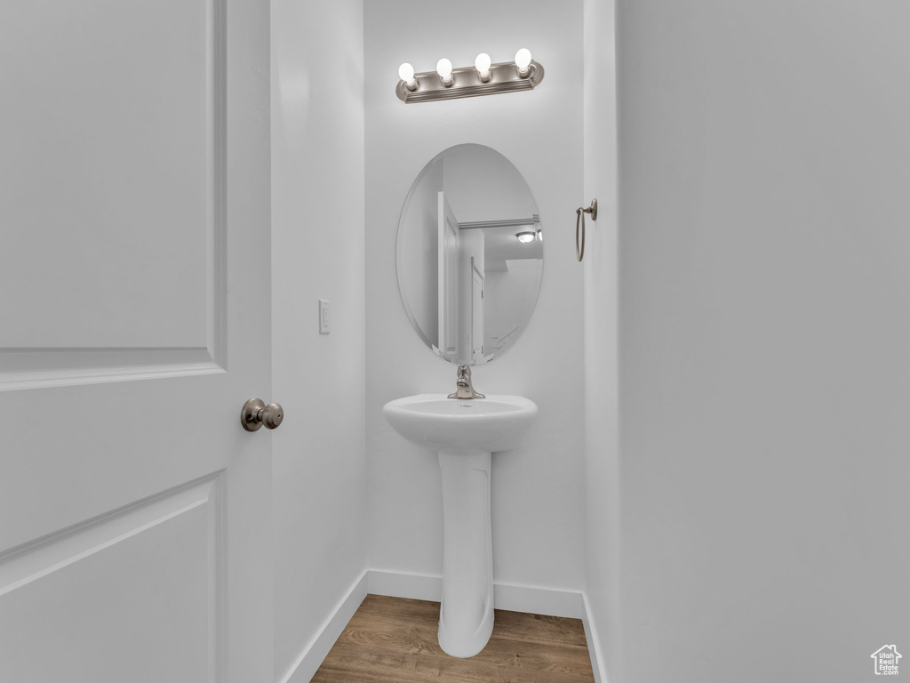 Bathroom featuring wood finished floors and baseboards