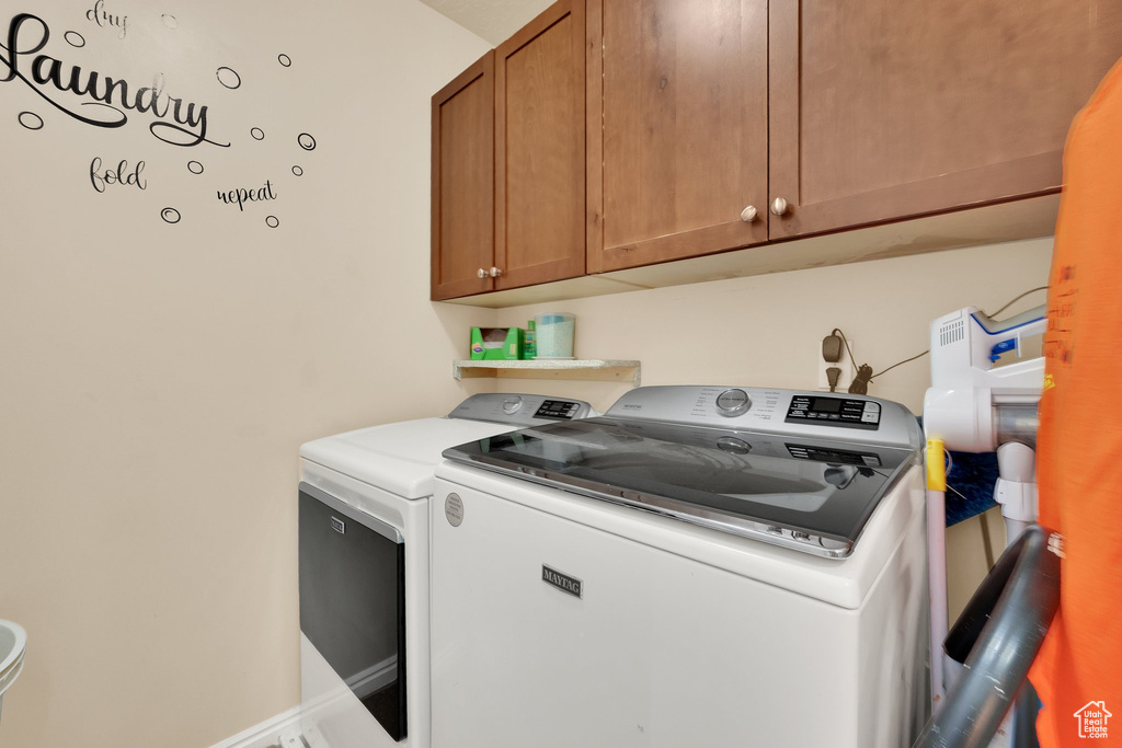 Washroom with washing machine and dryer and cabinet space