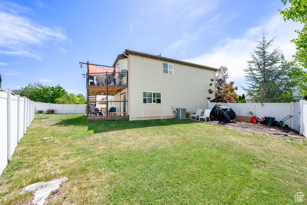 Back of house featuring central air condition unit and a deck