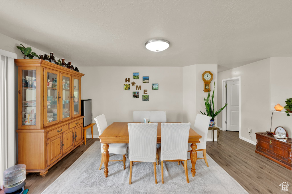 Dining room featuring light wood-type flooring and baseboards
