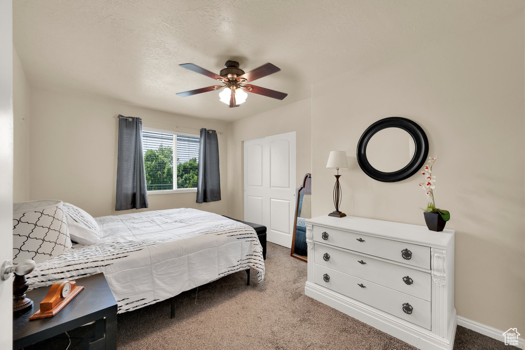 Bedroom featuring carpet floors, baseboards, and ceiling fan