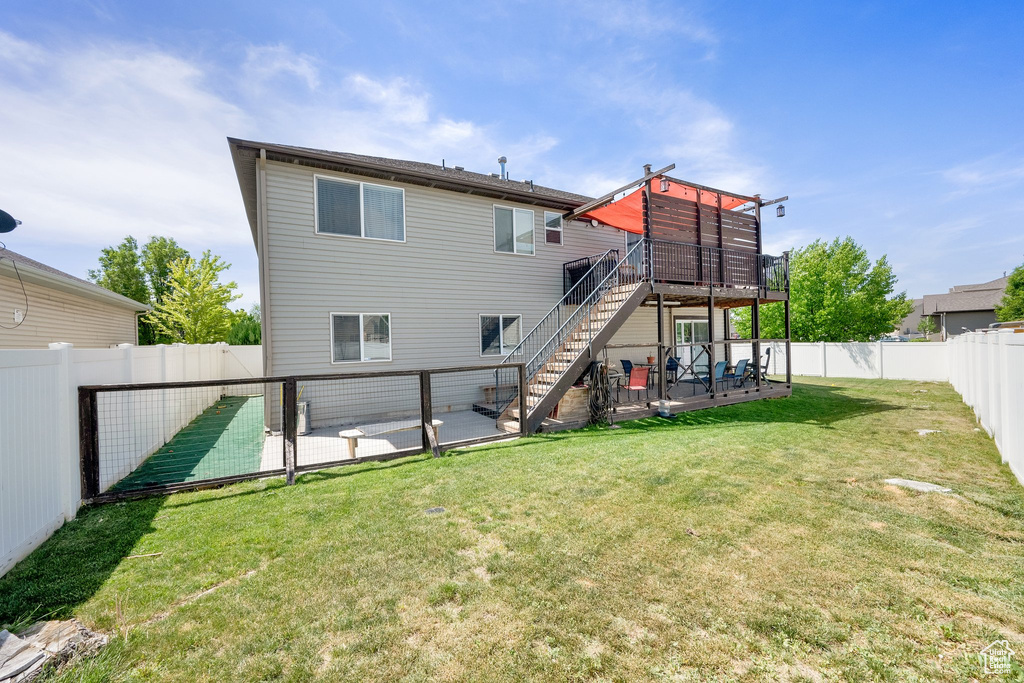 Back of house with stairs, a deck, a patio area, and a gate