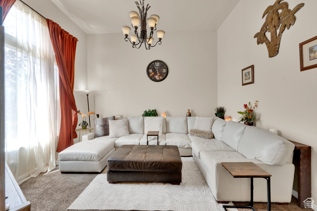Living area featuring carpet and a chandelier