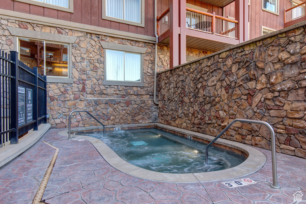 View of pool featuring a hot tub
