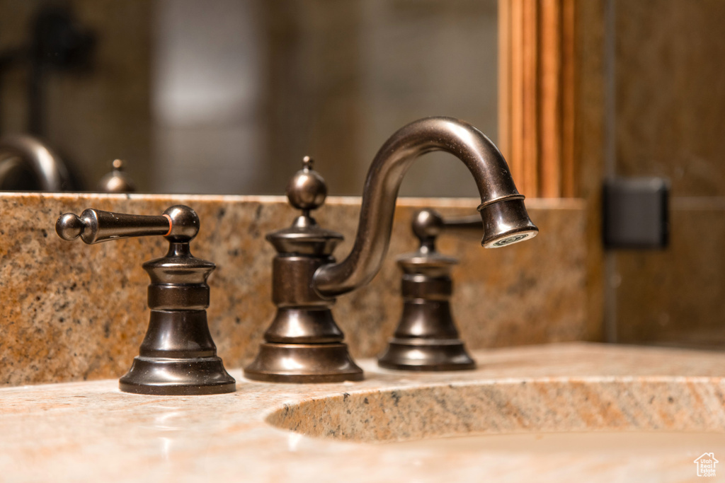 Bathroom view of a sink and decorative backsplash
