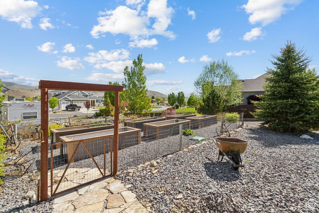 View of yard featuring a vegetable garden and a mountain view