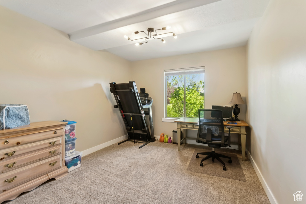 Carpeted office with baseboards and a chandelier
