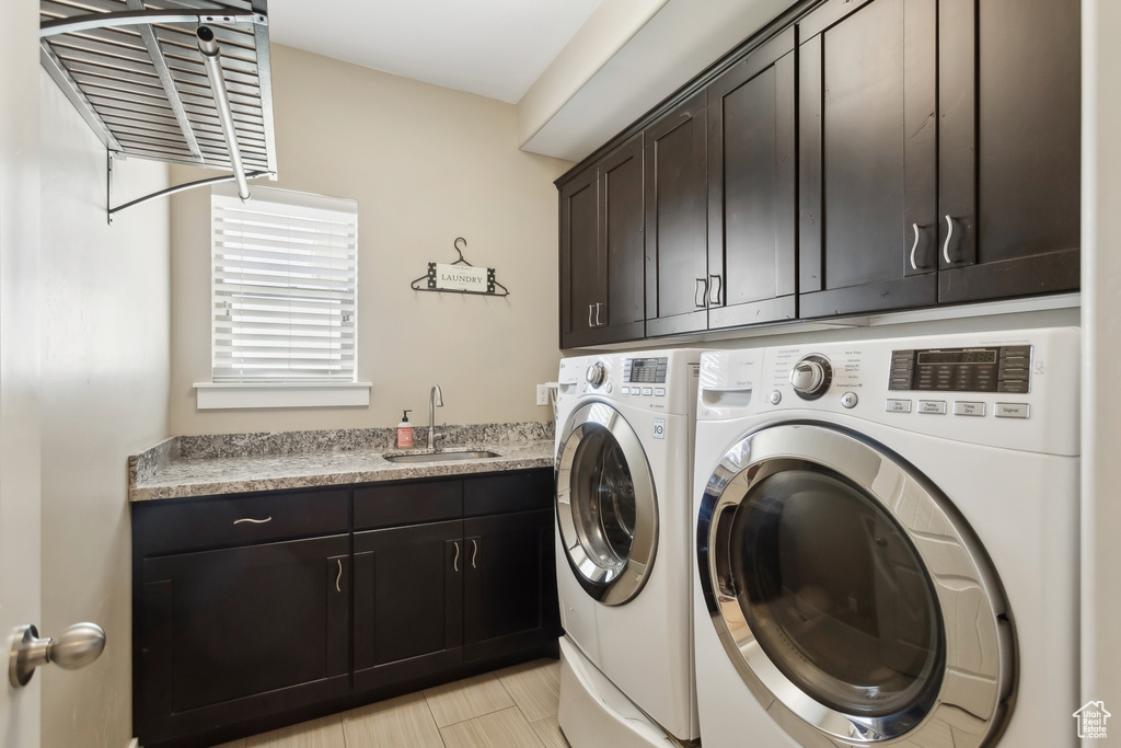Laundry room featuring cabinet space and washer and clothes dryer