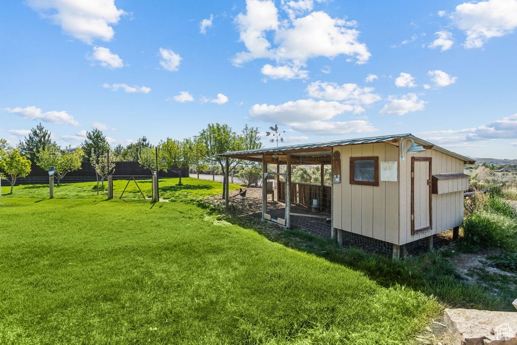 View of poultry coop featuring a yard