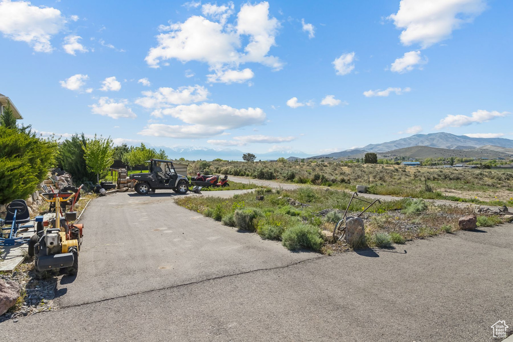 View of asphalt driveway with a mountain view