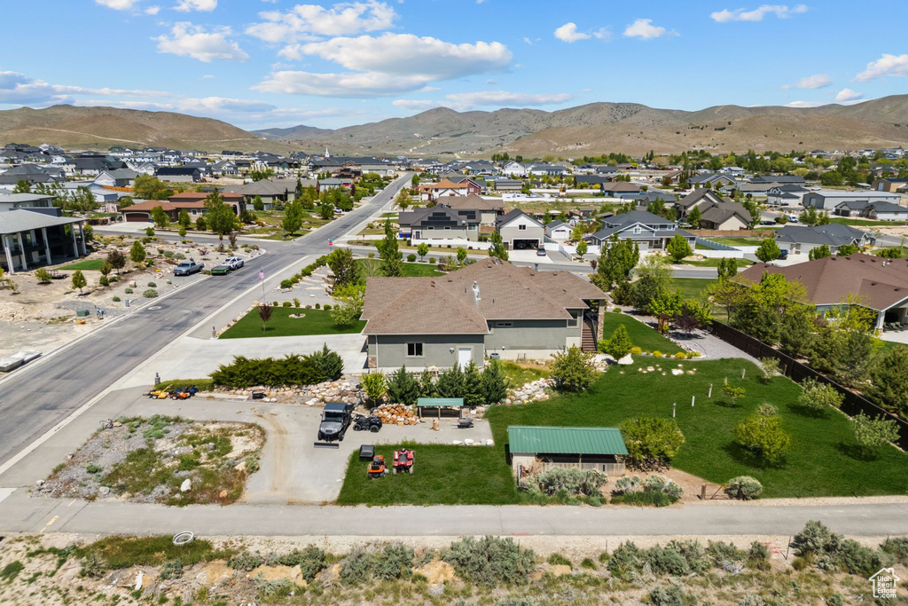 Aerial perspective of suburban area featuring a mountain backdrop