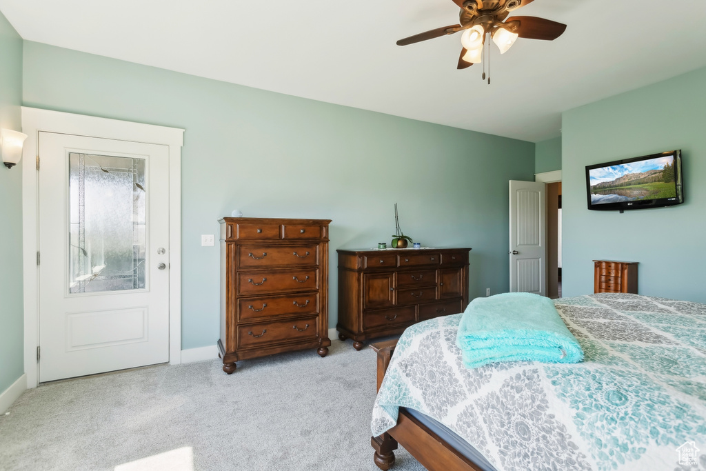 Carpeted bedroom featuring baseboards and ceiling fan