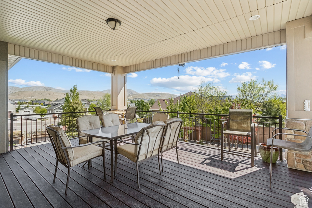 Deck featuring outdoor dining area and a mountain view