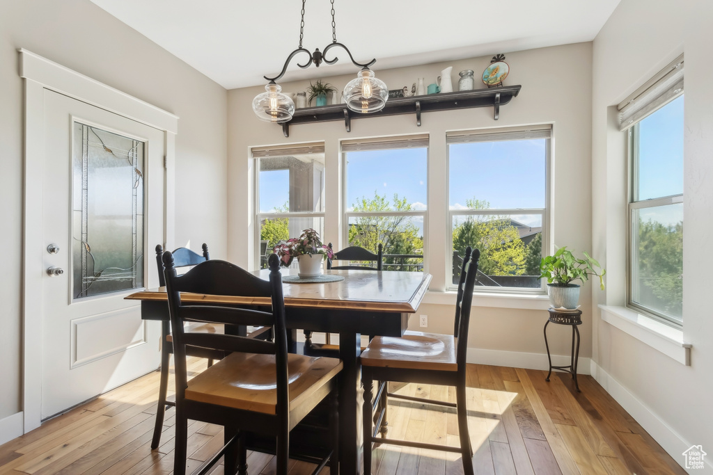 Dining area with light wood-style floors and baseboards