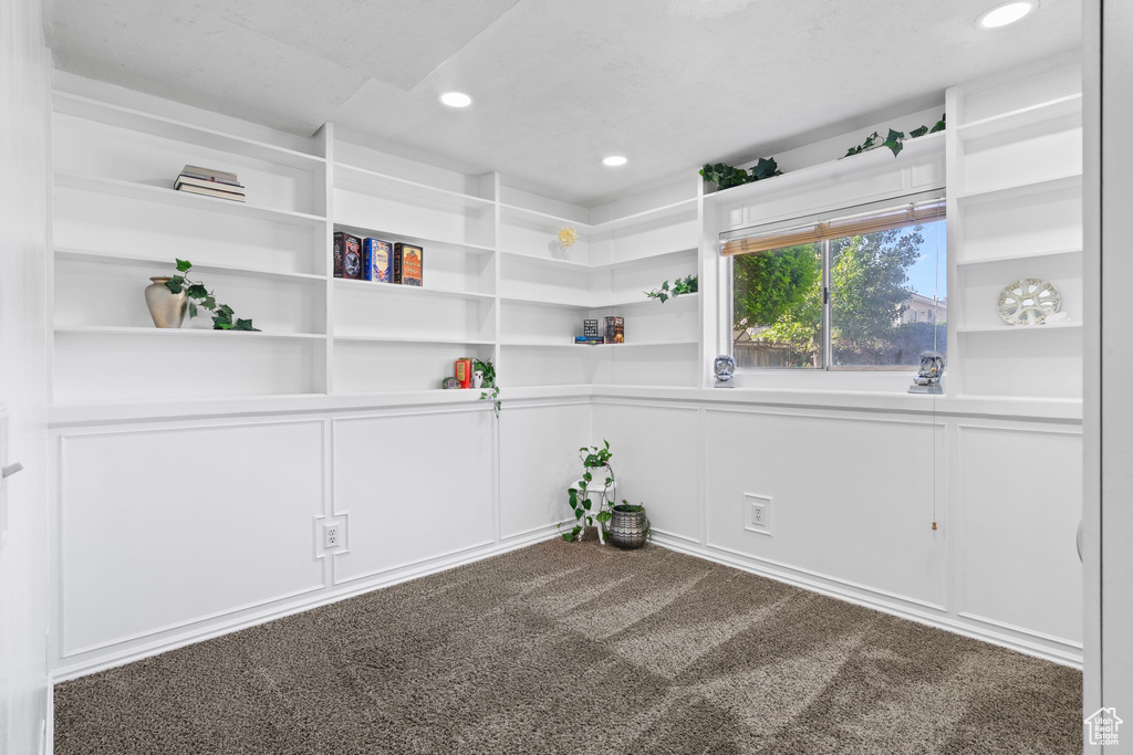 Spare room with a decorative wall, carpet flooring, recessed lighting, and built in features