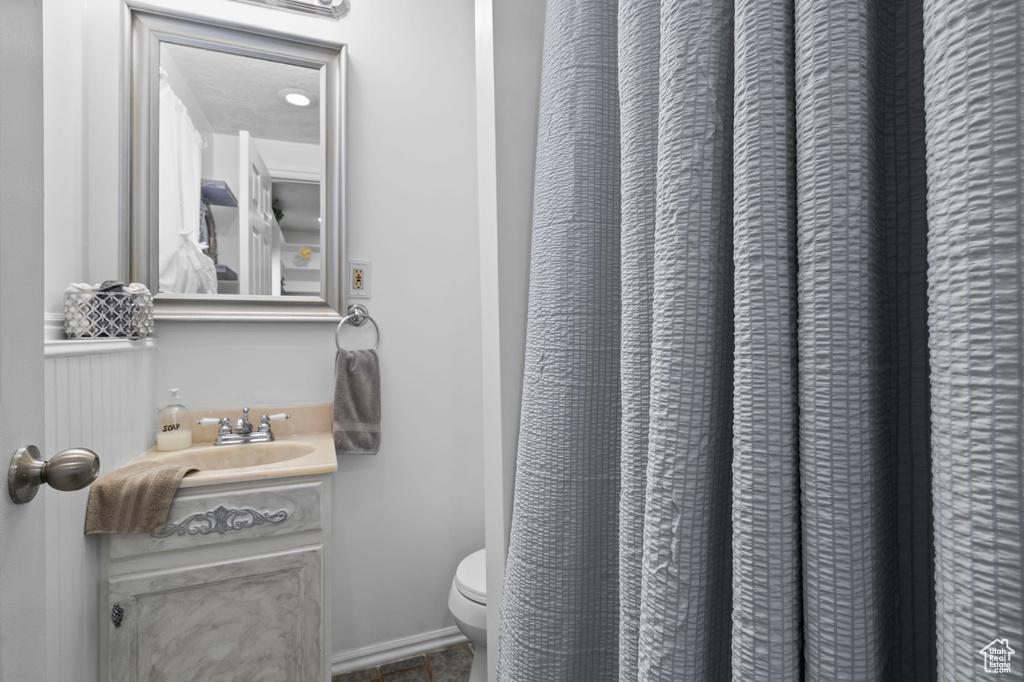 Full bathroom with toilet and vanity
