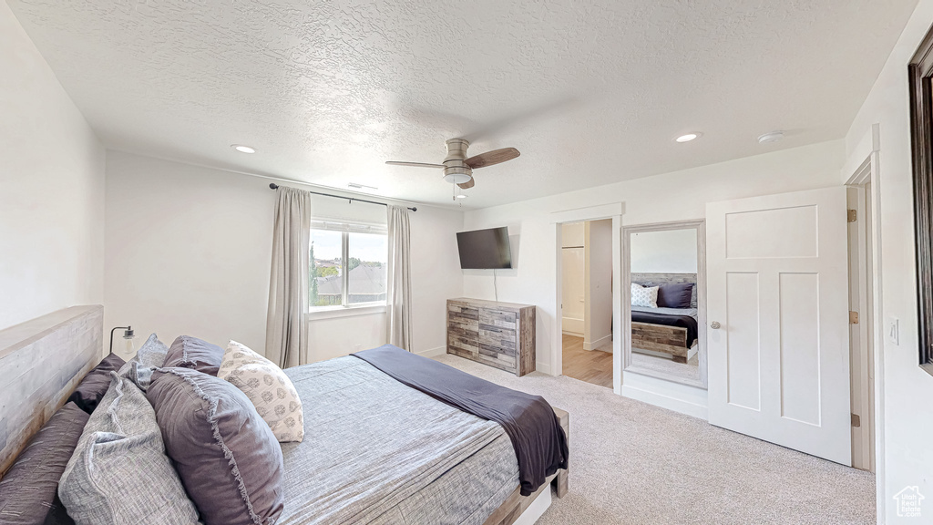 Bedroom featuring a textured ceiling, recessed lighting, carpet, and ceiling fan