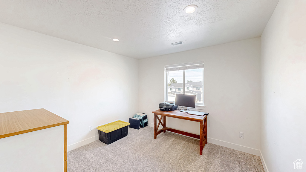 Office featuring carpet flooring, baseboards, a textured ceiling, and recessed lighting