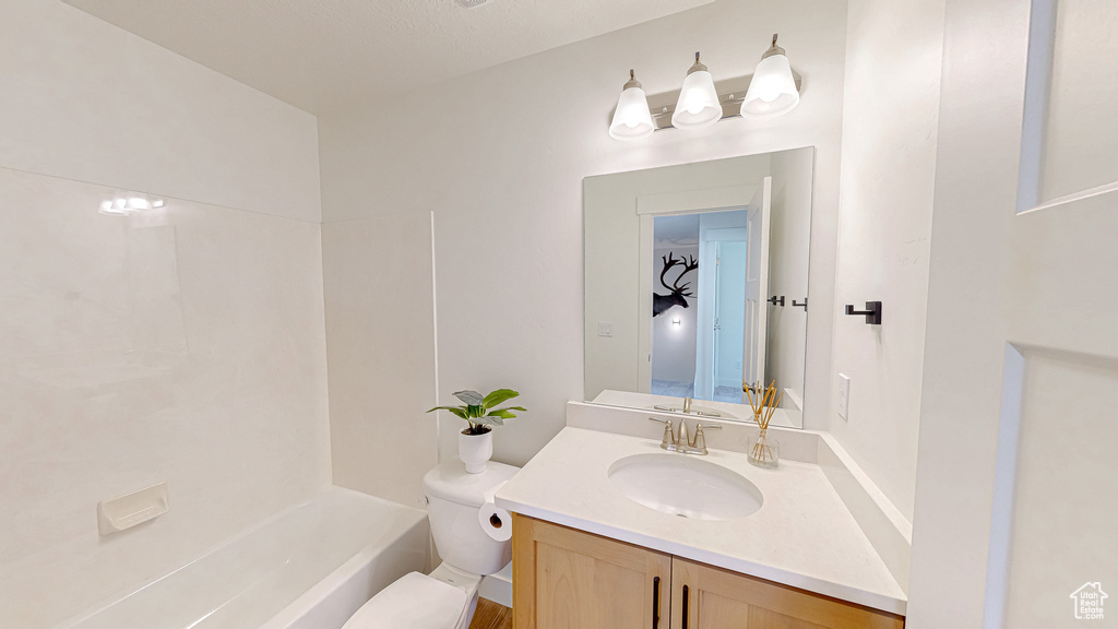 Full bath with toilet and vanity