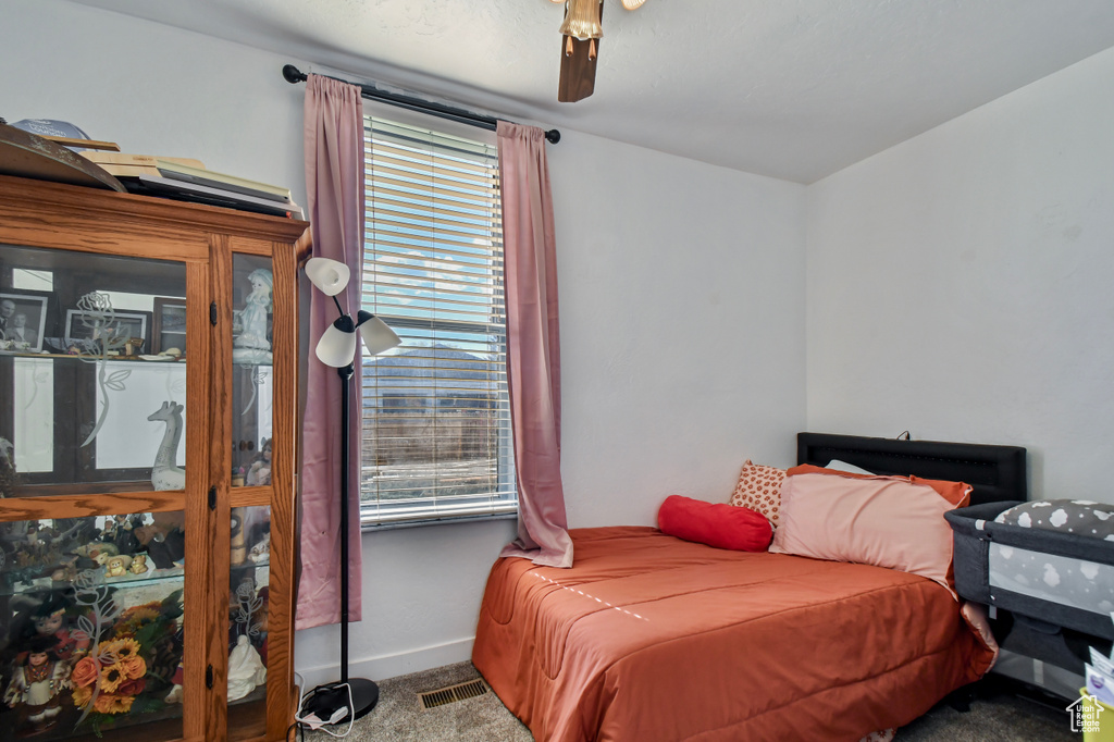 Bedroom featuring carpet, a ceiling fan, and baseboards
