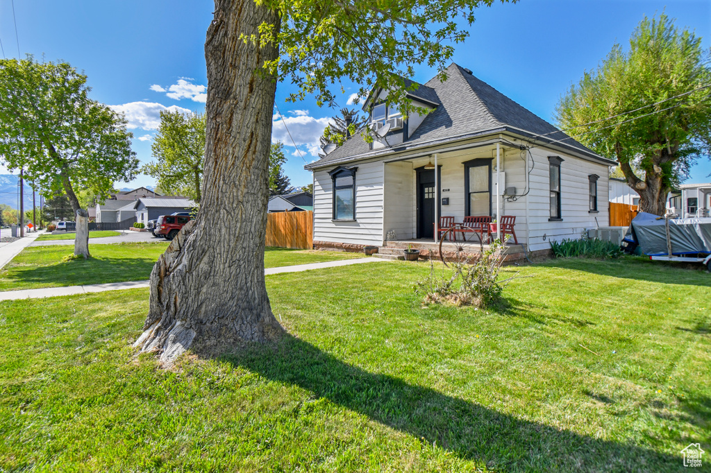 View of front of house with a porch and roof with shingles