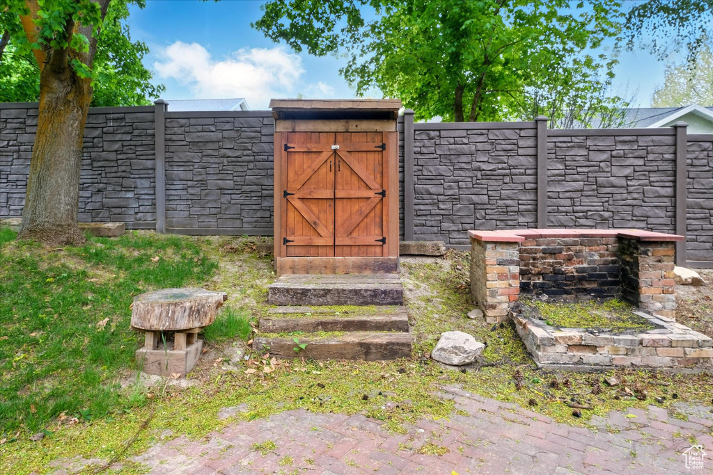 View of outdoor structure featuring a gate and fence