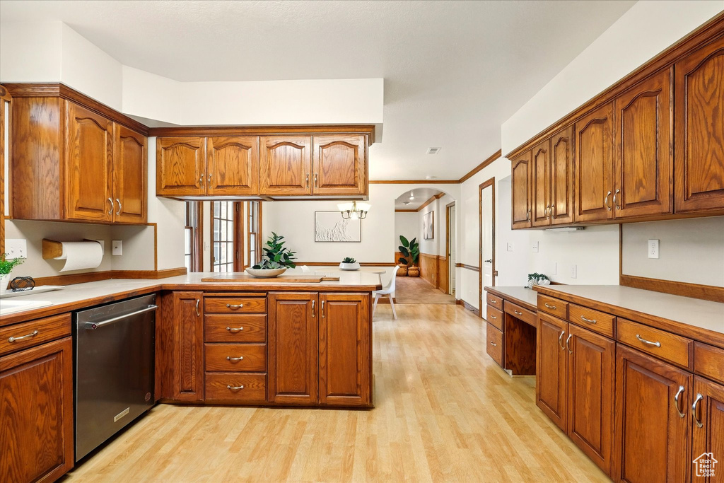 Kitchen with stainless steel dishwasher, light wood-type flooring, brown cabinets, a peninsula, and light countertops