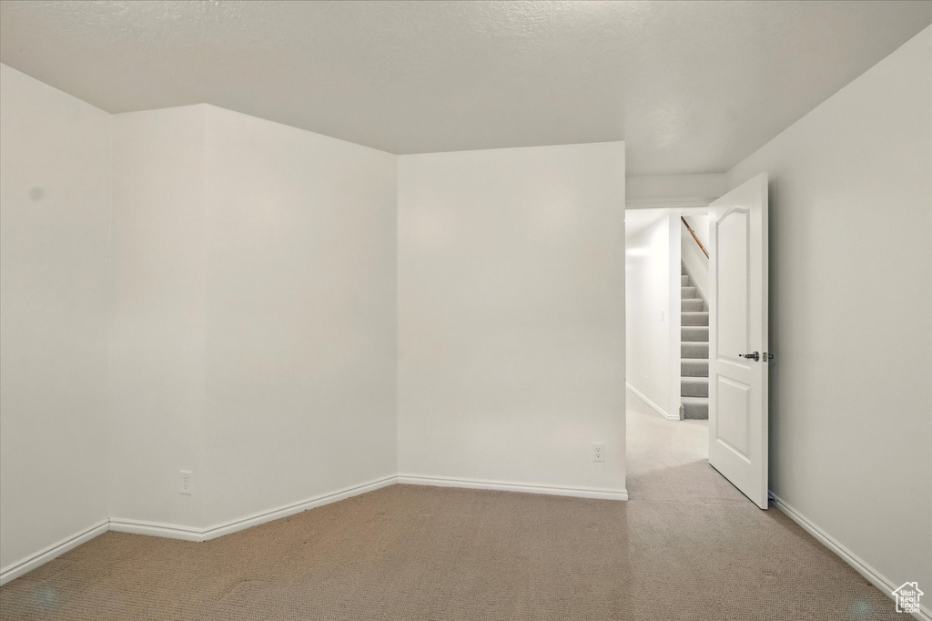 Empty room with carpet and baseboards