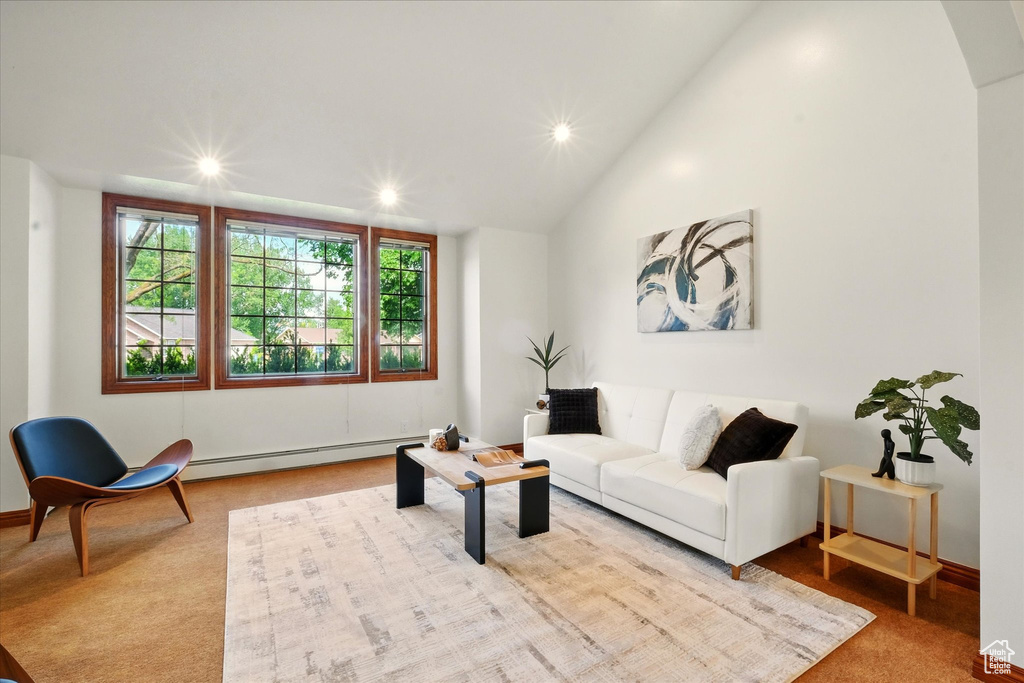 Living room with a baseboard radiator, recessed lighting, lofted ceiling, and baseboards