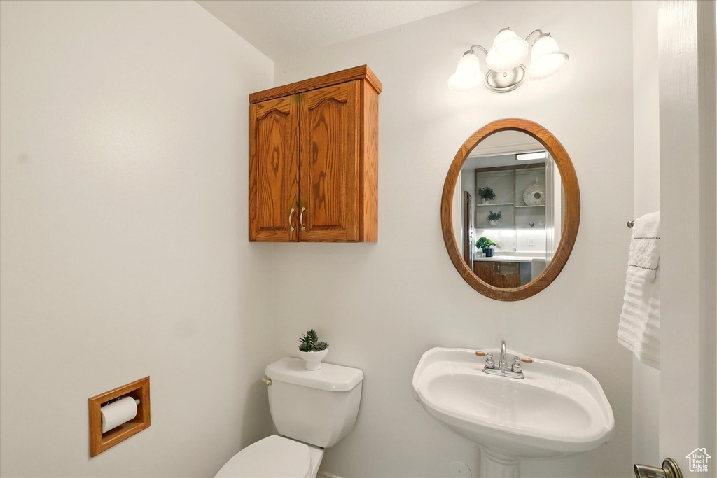 Half bath with a sink and toilet