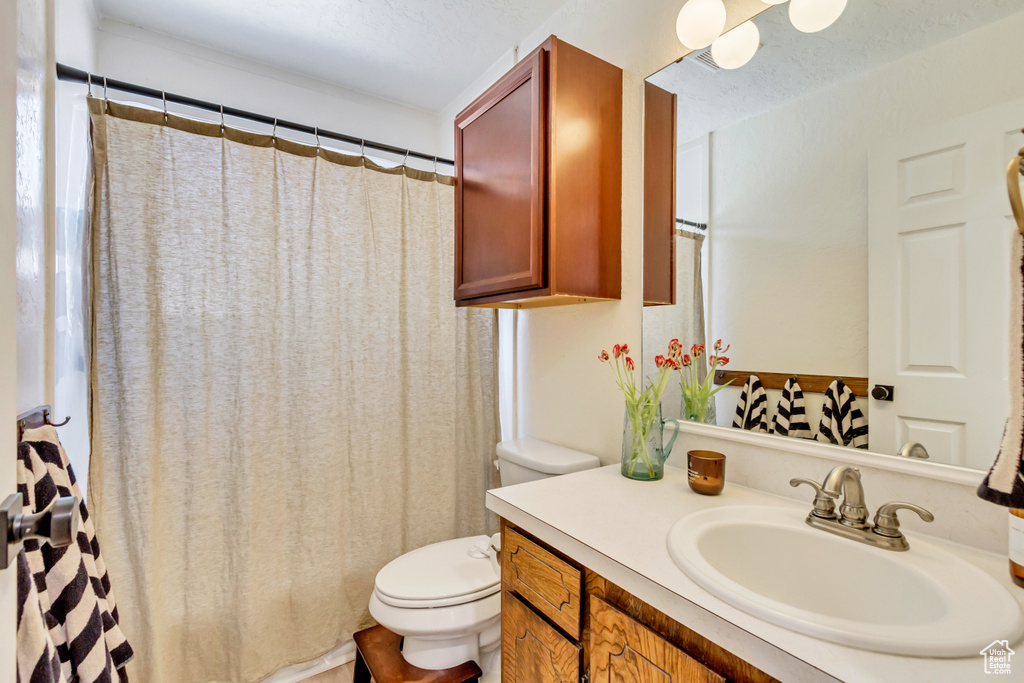 Full bathroom featuring toilet and vanity