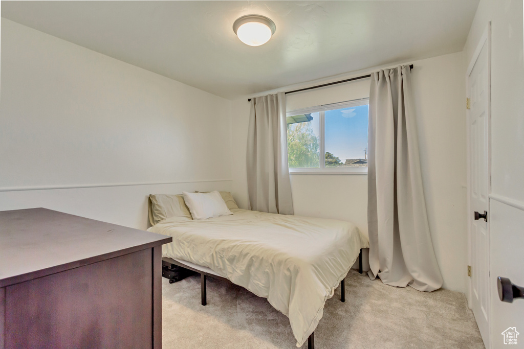 Bedroom with light colored carpet