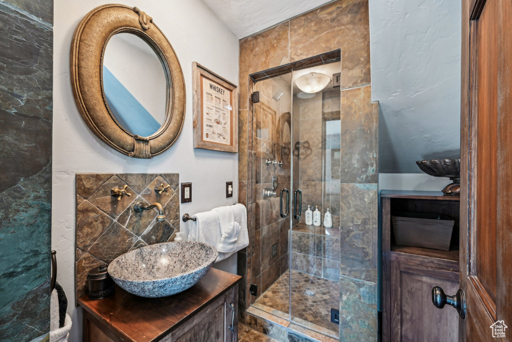 Full bathroom featuring a stall shower and vanity