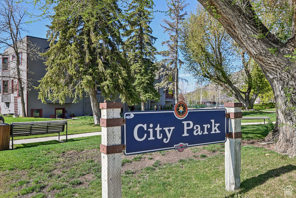 Community / neighborhood sign featuring a yard
