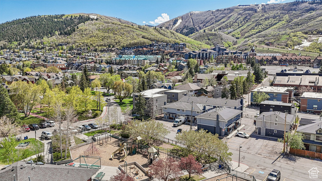 Aerial view of property's location with mountains and nearby suburban area