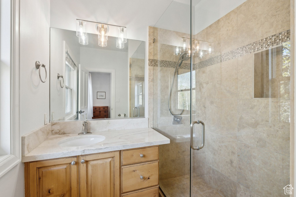 Bathroom with a stall shower and vanity