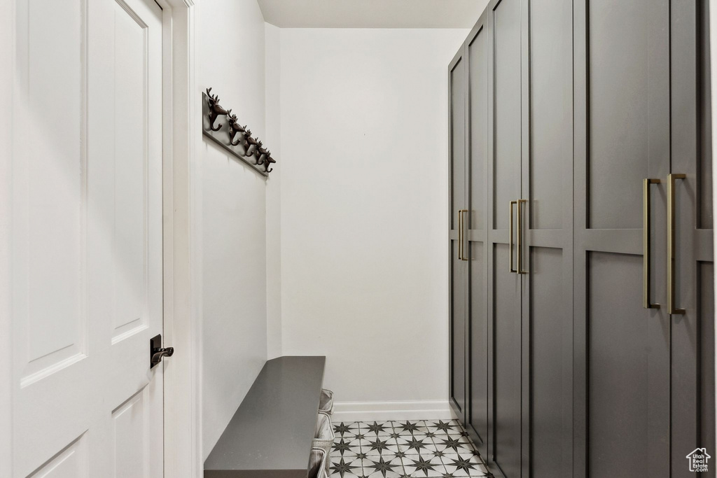 Mudroom with light flooring and baseboards