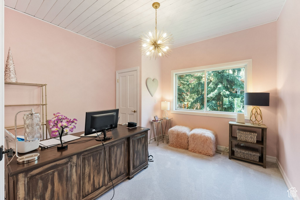 Office space with a chandelier, light colored carpet, baseboards, and wood ceiling