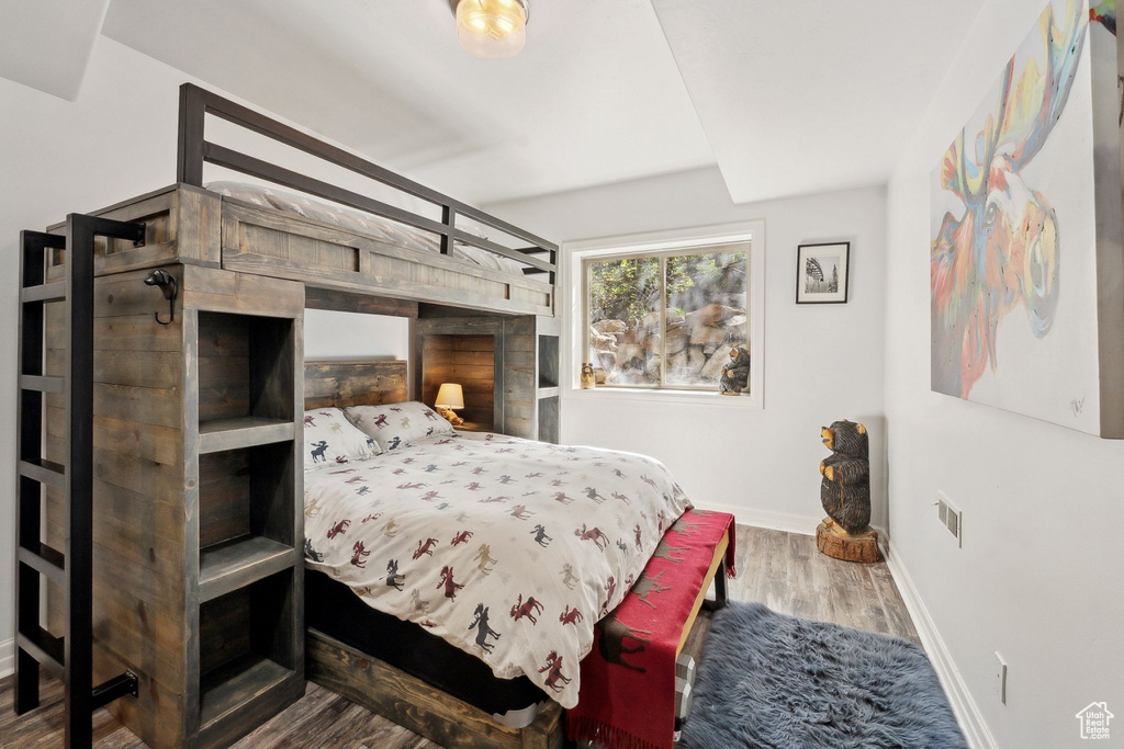 Bedroom with baseboards and wood finished floors