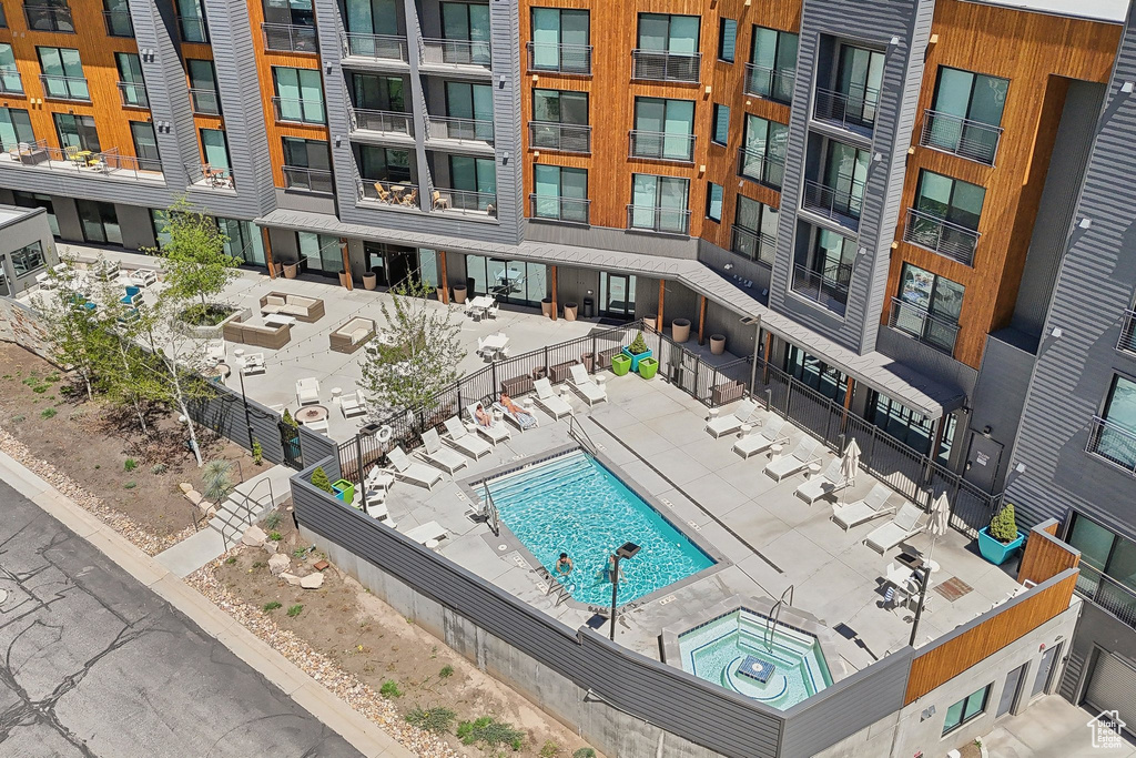 Community pool with fence and a hot tub