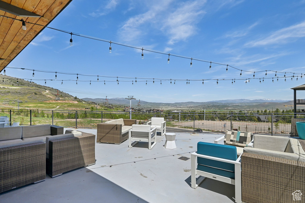 View of patio with outdoor lounge area and a mountain view