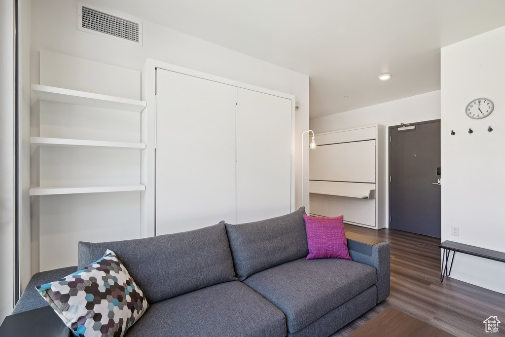 Living area featuring wood finished floors and recessed lighting
