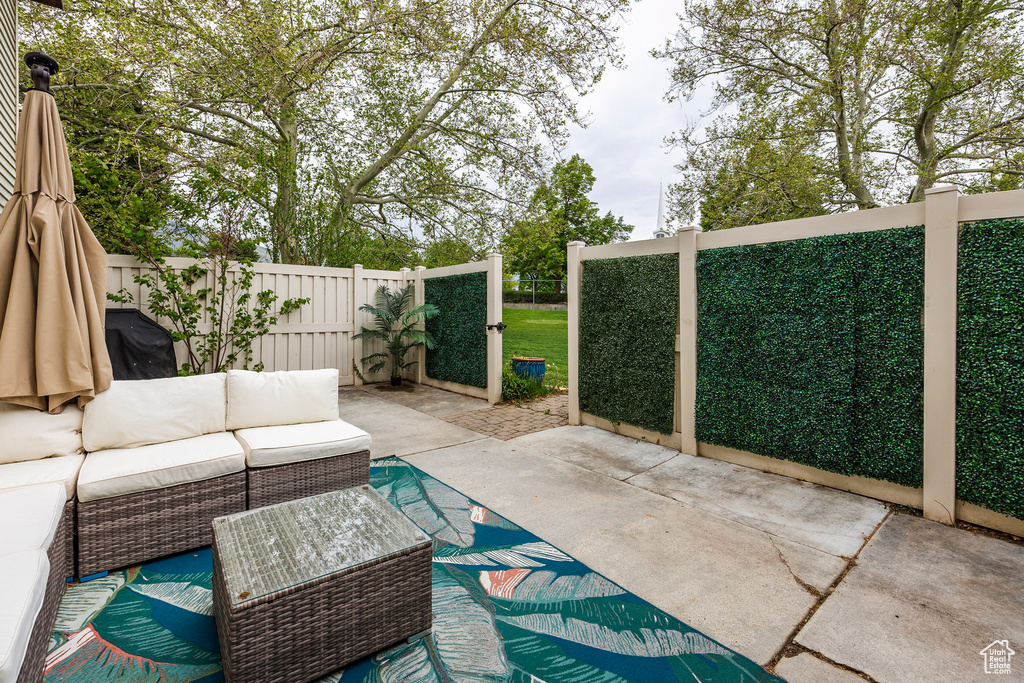 View of patio with outdoor lounge area and fence