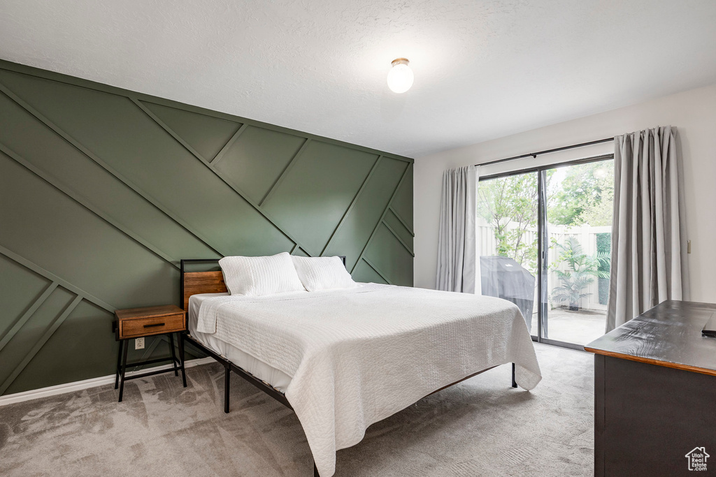Bedroom featuring access to exterior and light colored carpet