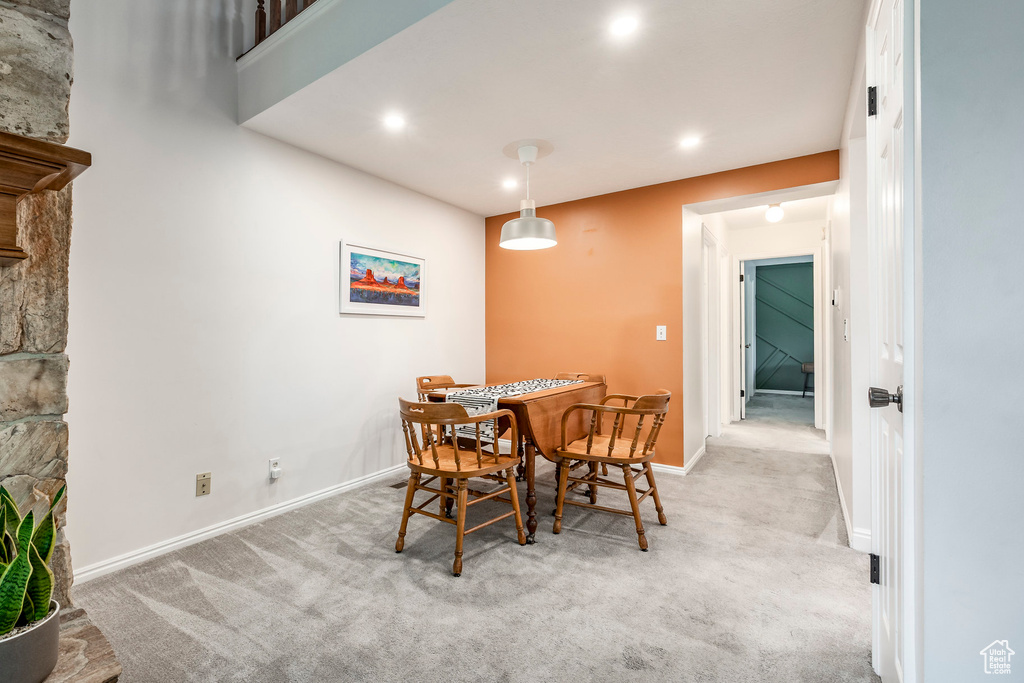 Dining space with carpet, baseboards, and recessed lighting
