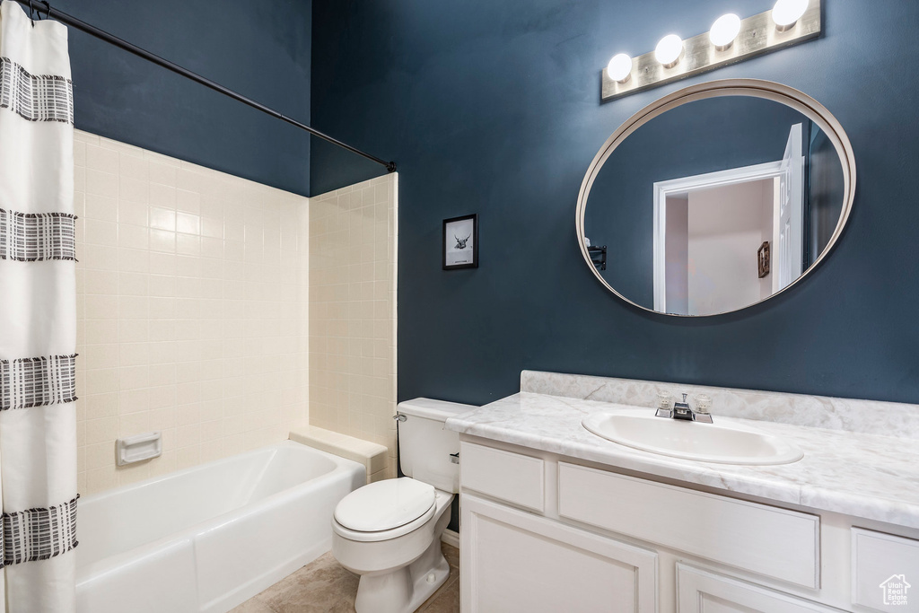 Full bath with toilet, vanity, shower / tub combo, and tile patterned flooring