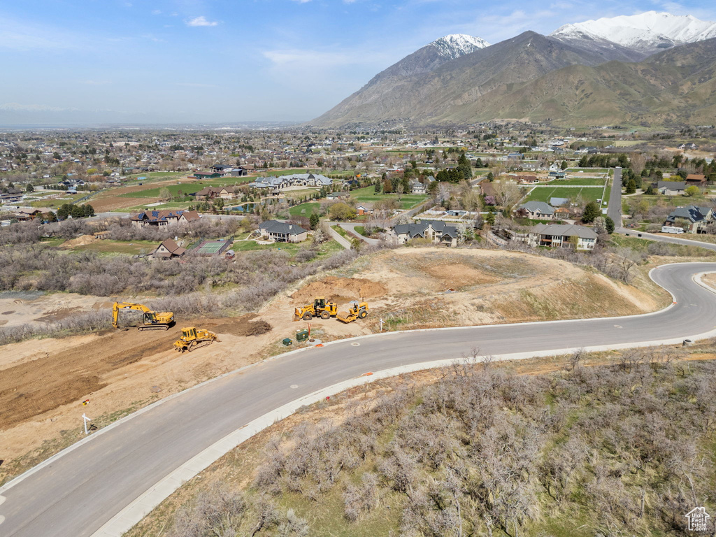 Aerial view of property's location with a mountainous background and nearby suburban area