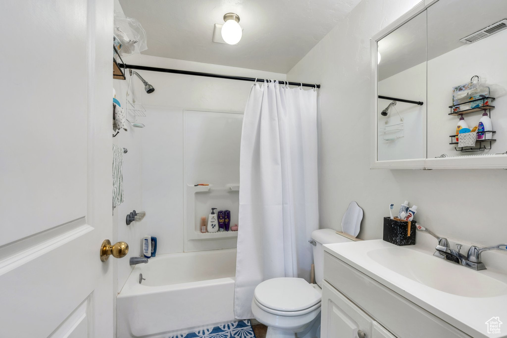 Full bath with toilet, vanity, and shower / bathtub combination with curtain