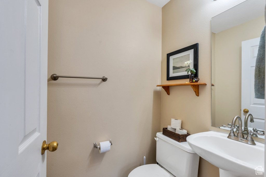 Half bath featuring a sink and toilet