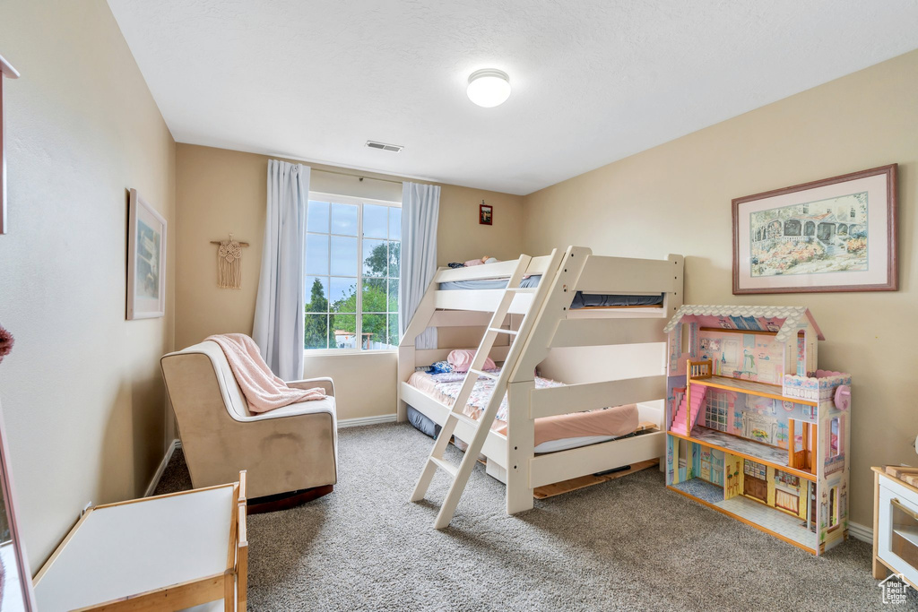 Bedroom with carpet floors and baseboards